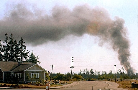 Smoke billows from a fire that consumed a garage