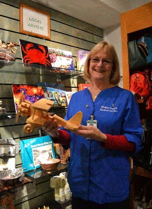Michelle Suggs holds a plane that a Coupeville resident made and donated to be sold at the hospital’s gift shop.