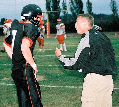 Head coach Ron Bagby gives instructions to his son