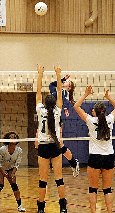 Oak Harbor's Claire Anderson prepares to drive home one of her 18 kills against Shorecrest as Priya Osborne (4) covers.