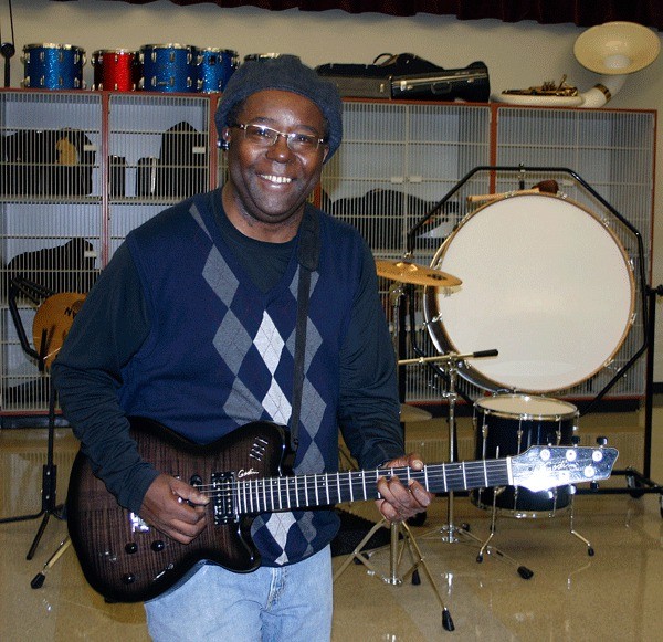 Coupeville School District music director Jamar Jenkins plays guitar in his classroom. Jenkins was a member of the soul band