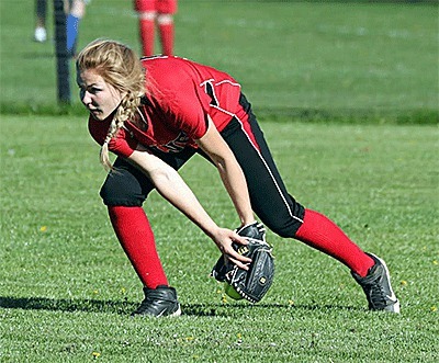Hope Lodell scoops up a ball in center field in the Wolves' win Thursday.