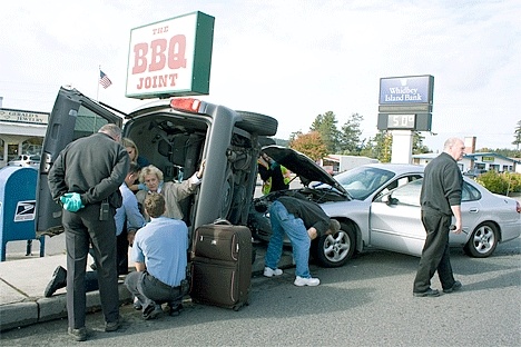 Paramedics assess Jaquline Legg's condition Wednesday afternoon after a two-car crash on Midway Boulevard in Oak Harbor.