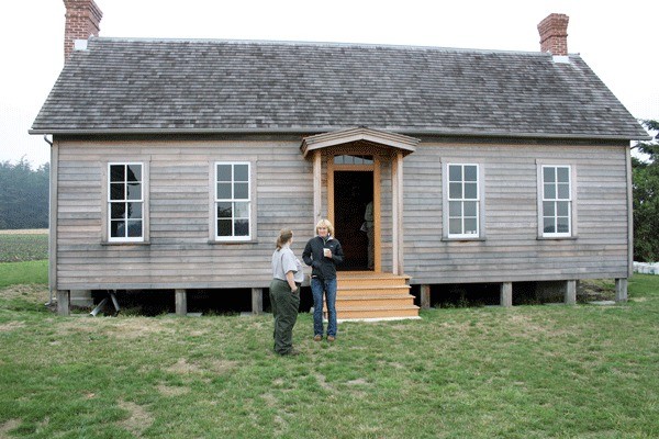 Ebey’s Landing National Historical Reserve staff members Laura Gansemer and Emi Gunn chat in front of the recently renovated Jacob Ebey House. Reserve officials released a long-range interpretive plan Wednesday morning during a preview of the updated historic building.