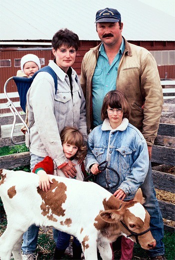 The Muzzall family in front of the farm about 15 years ago.  From top left