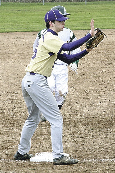 Oak Harbor third baseman Teddy Peterschmidt tells his catcher to hold the throw as a Sehome runner moves up a base.