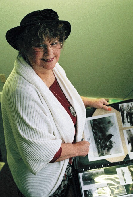 Sharon Nicholson peruses a scrapbook she compiled while collecting information for her book highlighting the experiences of Oak Harbor’s World War II veterans.