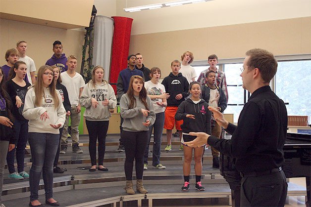 Oak Harbor High School Choir Director Darren McCoy coaches the Harbor Singers choir through warm-ups during class.