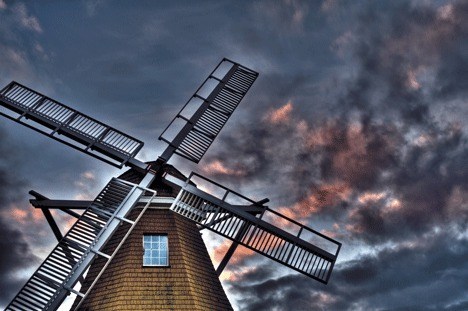 A beautiful red sky can be seen behind the windmill at Windjammer Park in a photograph by M. Denis Hill. He will be signing and selling his new book Feb. 13.