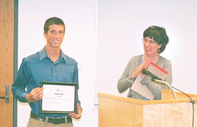 Recent Coupeville High School graduate Jordan Lamb stands with Island County Children’s Commission chairperson Janice O’Mahoney as he receives a Caught in the Act award given to youth who have made a positive impact in the community.