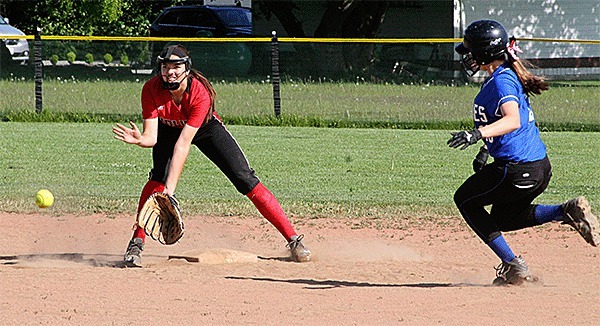 Coupeville shortstop Katrina McGranahan awaits a throw from catcher Lauren Rose in an attempt to stop a La Conner from stealing second.