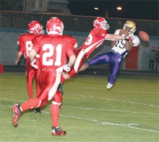 Stanwood defensive back Michael Vaughn tips the ball away from Oak Harbor wide receiver Rashaad Smith
