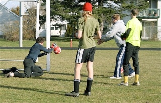 Assistant coach Gary Manker works a drill with the Wolf varsity and junior varsity goal keepers during a combined practice session at Mickey Clark Field.