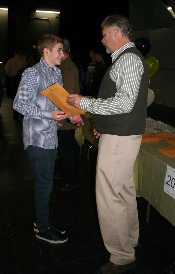 Ben McCornack accepts his academic letter from Oak Harbor High School principal Dwight Lundstrom.