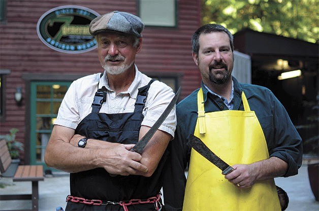 Greg and Nathan Gilles pose for a photo in front of their new butcher shop. They hope to open in two weeks