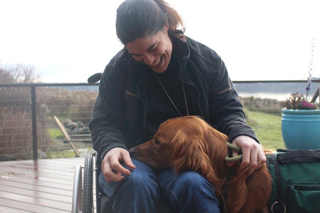 Melissa Mitchell works with her service dog