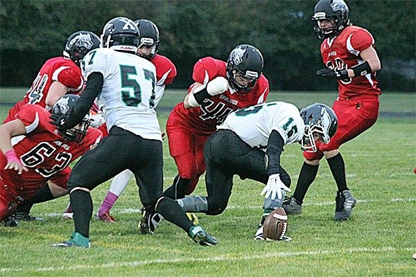 Coupeville's Lathom Kelley (44) hits Klahowya's Konnr Langholff (15) as he attempts to pick up a loose ball. The Wolves' Wiley Hesselgrave recovered the fumble moments later.