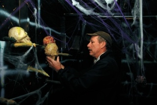 Volunteer Duncan Chalfant adjusts one of many skulls that lines the walls of Frightville