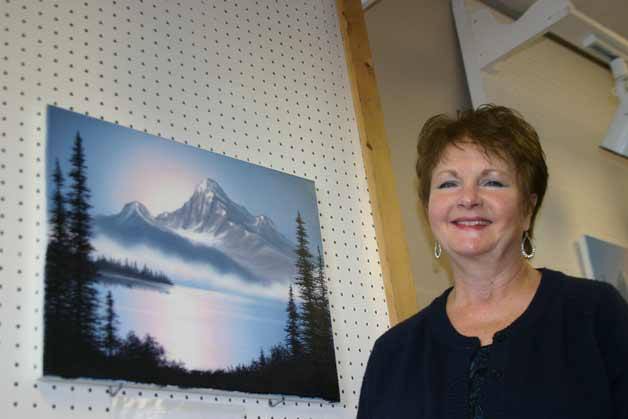 Koraley Orritt shows a painting created in adult oil painting classes at her new business