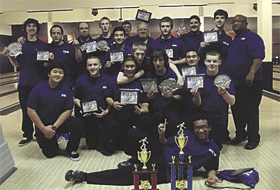 The Oak Harbor bowling teams show off their awards.
