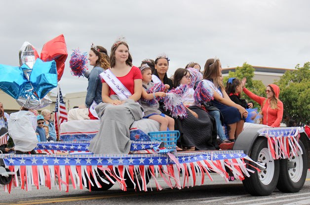 The queen and princess from the three divisions rode on a float in the Fourth of July parade with Miss Oak Harbor Royalty.