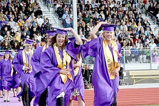 Members of the OHHS graduating class hold on to their hats as they fight the wind during the June 16 ceremony