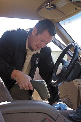 Tim Shriver Jr. of CDEX Inc. uses a high-tech scanning device to check for traces of meth in a vechicle that was purchased from O&J Sales car lot. Due to recent lab results