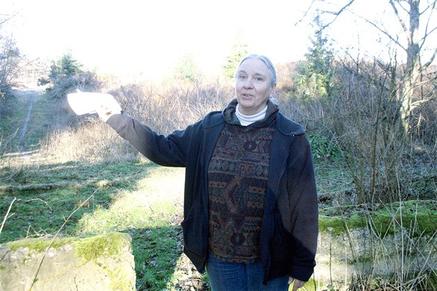 Central Whidbey resident Debbie Vrungos is concerned about a proposal to expand a gravel pit near her home because of the company’s history of violating environmental rules. She stands in front of a clear-cut area that’s supposed to serve as a buffer between the operation and homes.
