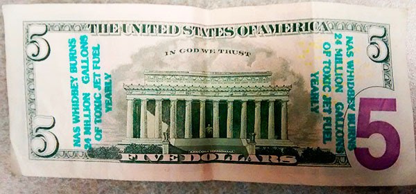 Money stamped with anti-Navy rhetoric is being distributed in the community. Citizen groups that have been critical of the Navy say they are not responsible.