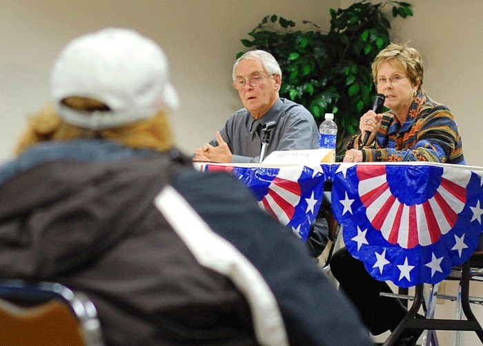 Oak Harbor City Council candidates Larry Eaton and Beth Munns listen to a question from SE Pioneer Way merchant Kelly Beedle.