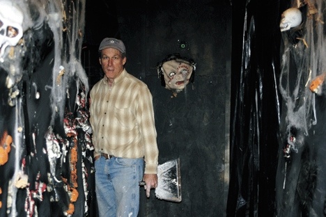 Duncan Chalfant works amidst skulls that line some of the hallways of Frightville