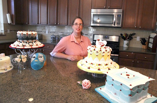 Sandra Daggett poses with some of her prize winning creations. The Oak Harbor baker opened her business last month and is already supplying island residents with specialty cakes and other sweet creations.