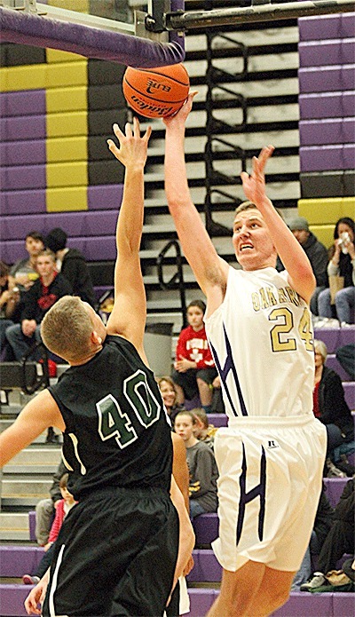 Oak Harbor's Ben Fikse shoots over the defense of Edmonds-Woodway's Ryan Peterson.