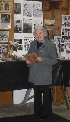 Trudy Sundberg stands in front of a display commemorating her late husband John. This fall