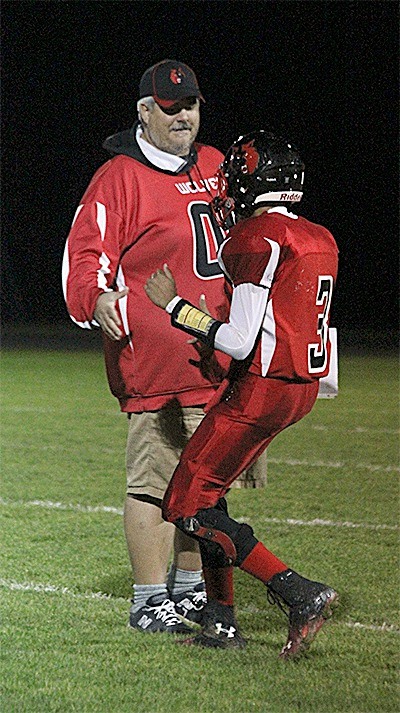 Coach Tony Maggio greets one of his players before a recent game. Maggio resigned last week after coaching the Wolves three years.