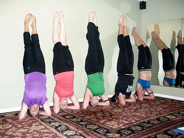 UnSizeMe Fitness and Wellness members do headstands during a “headstands - return to childhood” class. From left are Linda Meindhart