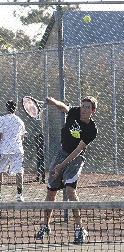 Aaron Curtin serves in the Wolves' match with Archbishop Murphy Wednesday. A day earlier
