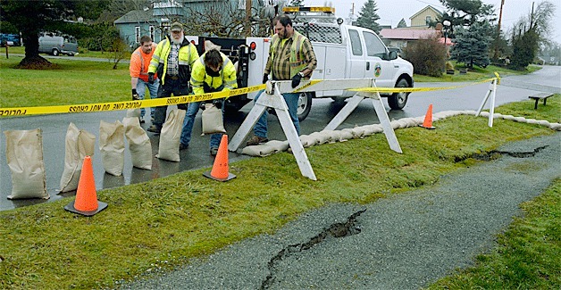 Coupeville town staff cordon off a Front Street trail threatened by bluff erosion.