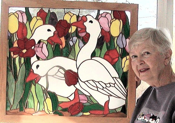 Garry Oak featured artist Sandy Dubpernell poses with one of her stained glass pieces.