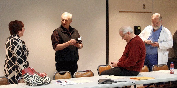 Hospital Commissioner Anne Tarrant chats with Commissioner Ron Wallin before Monday’s Whidbey General Hospital Board meeting alongside commissioners Roger Case and Paul Zaveruha. The commissioners unanimously approved running a $50 million expansion bond that will go before voters May 17.