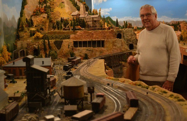 Miniature train enthusiast Jack Tingstad stands surrounded by his collection. Tingstad is holding his 13th-annual model railroad open house 10 a.m. to 4 p.m. Saturday