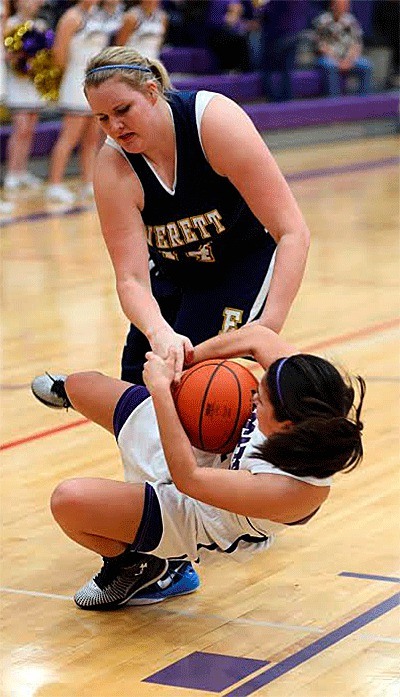 Oak Harbor's AnnaBelle Whitefoot wrestles the ball away from Everett's Katy Hedington.