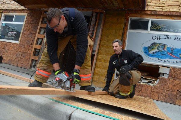 Oak Harbor firefighters Jon Jansen and Steve McCalmont saw up a makeshift repair for Off the Hook