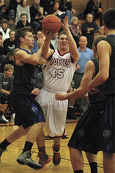 Coupeville's Gabe Wynn is fouled on the way to the hoop Tuesday.