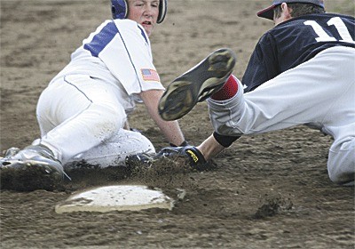 Coupeville third baseman Aaron Curtin attempts to tag a South Whidbey runner in Friday's game.