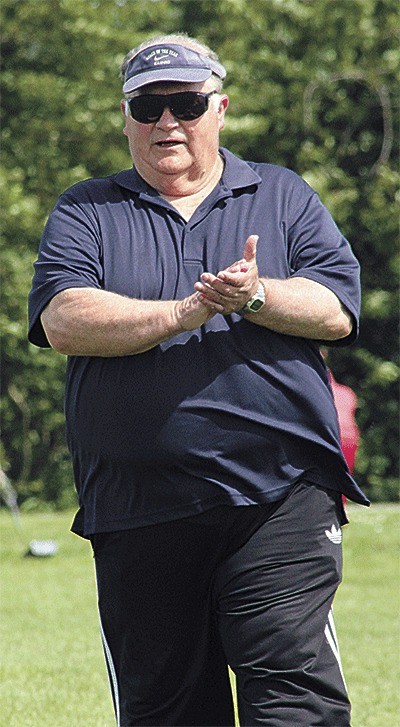 Orson Christensen encourages players at a the Coupeville High School spring football camp.