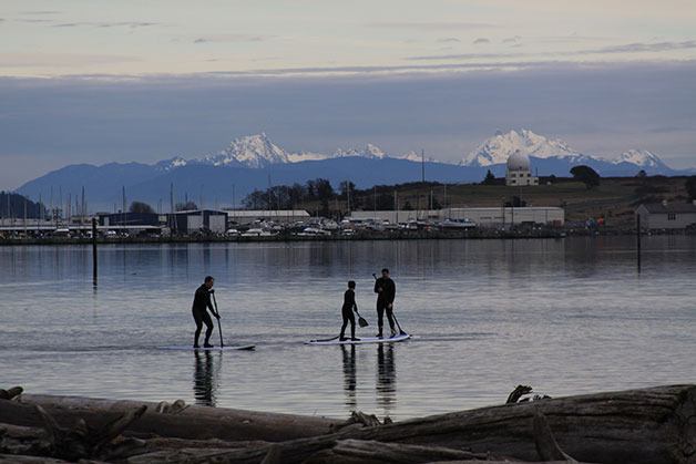 Stand-up paddleboarders take to the water in Oak Harbor on a January day in 2014.