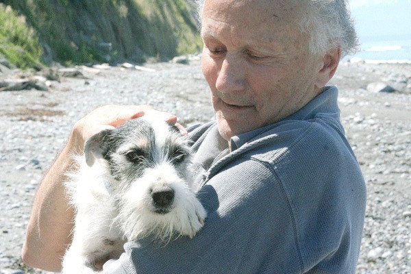 Richard Anderson embraces Sophie after she was rescued. The 7-year-old Jack Russell terrier spent a week stranded on a bluff.