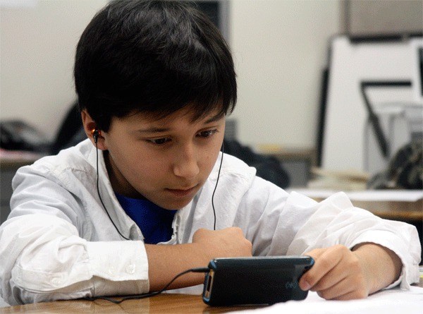 Fifth grader Steven Vallery watches a math video on an iPod during a lesson led by his teacher Duane Sisto.