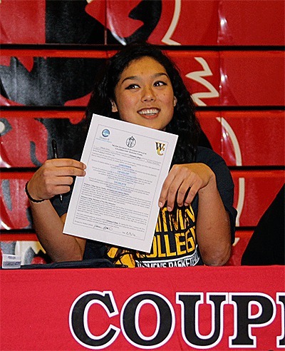 Makana Stones shows off her signed letter of intent to play basketball for Whitman College.